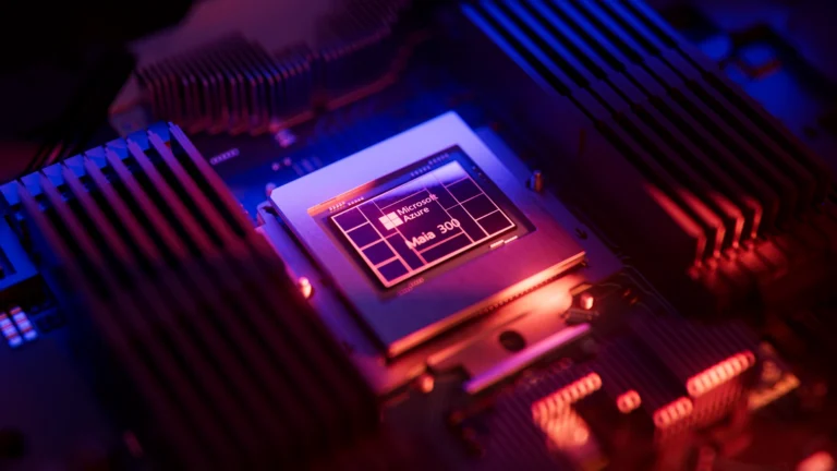 Microsoft Azure Maia 300 processor chip mounted on a circuit board with heatsinks, illuminated by blue and red lighting.